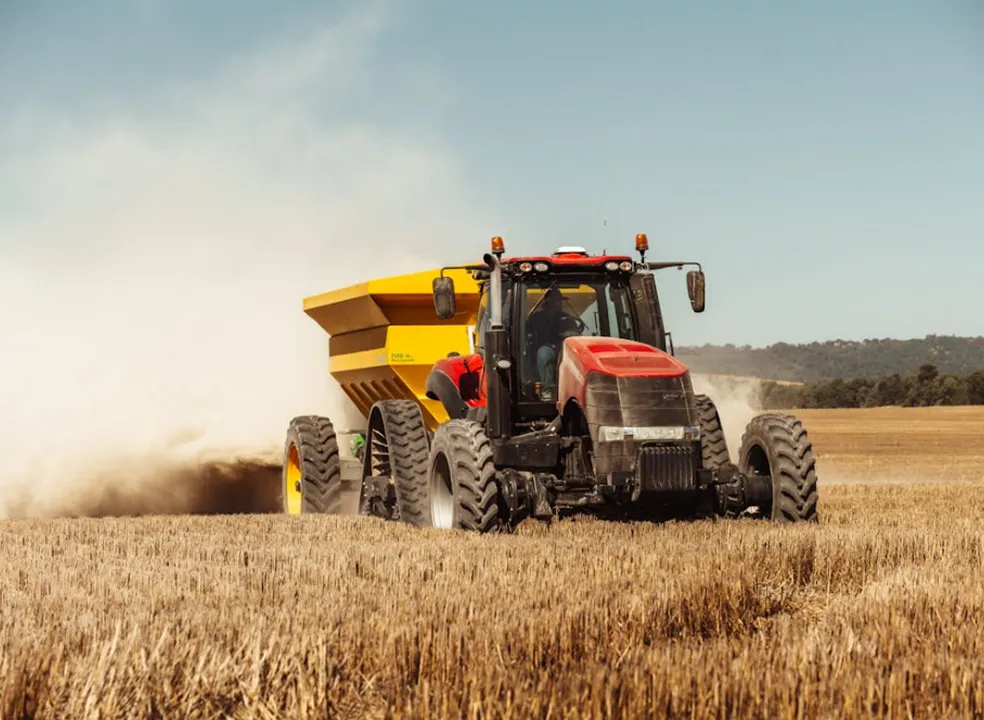 Tractor harvesting a golden wheat field